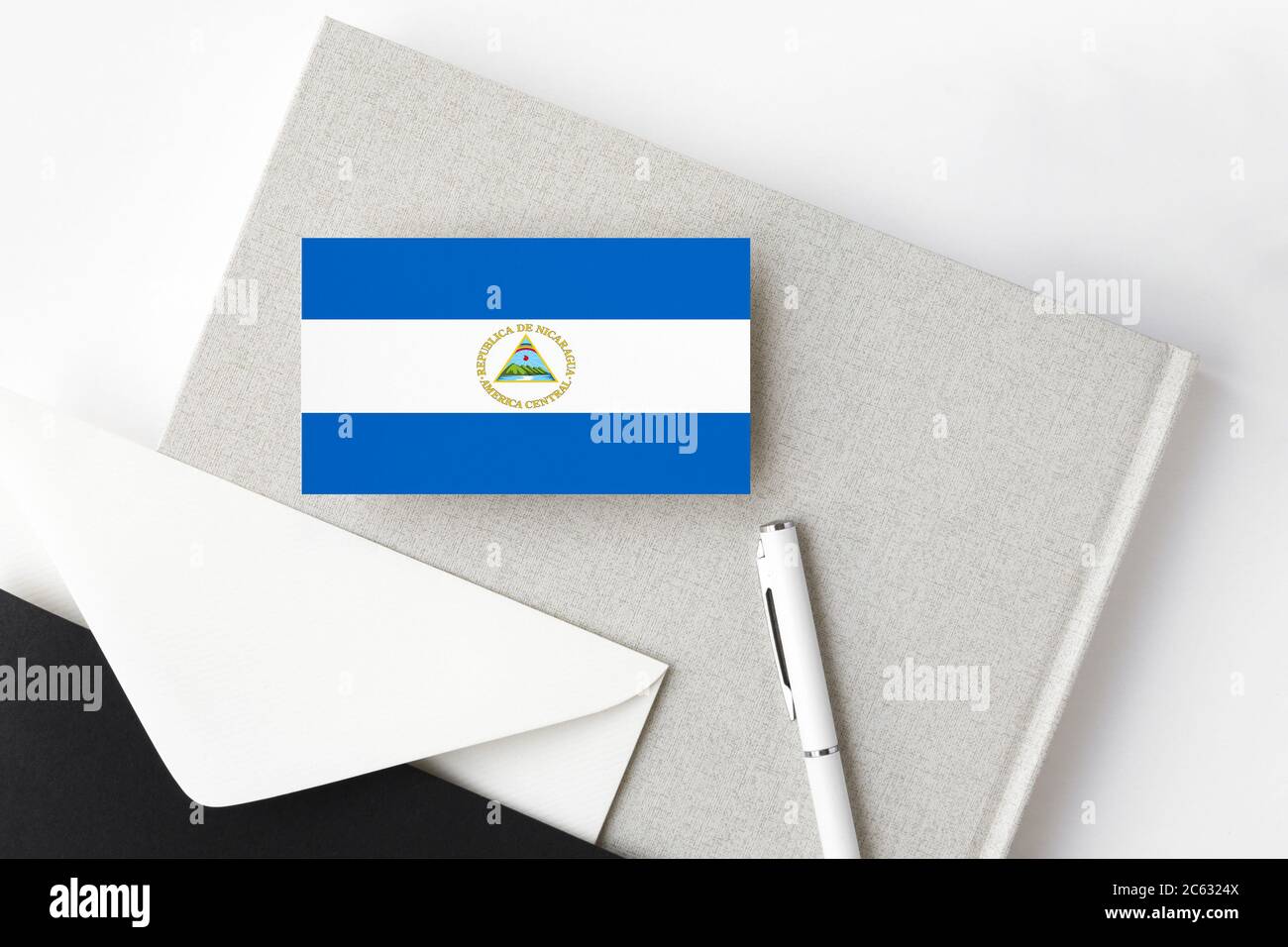 Nicaragua Flag On Minimalist Letter Background National Invitation   Nicaragua Flag On Minimalist Letter Background National Invitation Envelope With White Pen And Notebook Communication Concept 2C6324X 