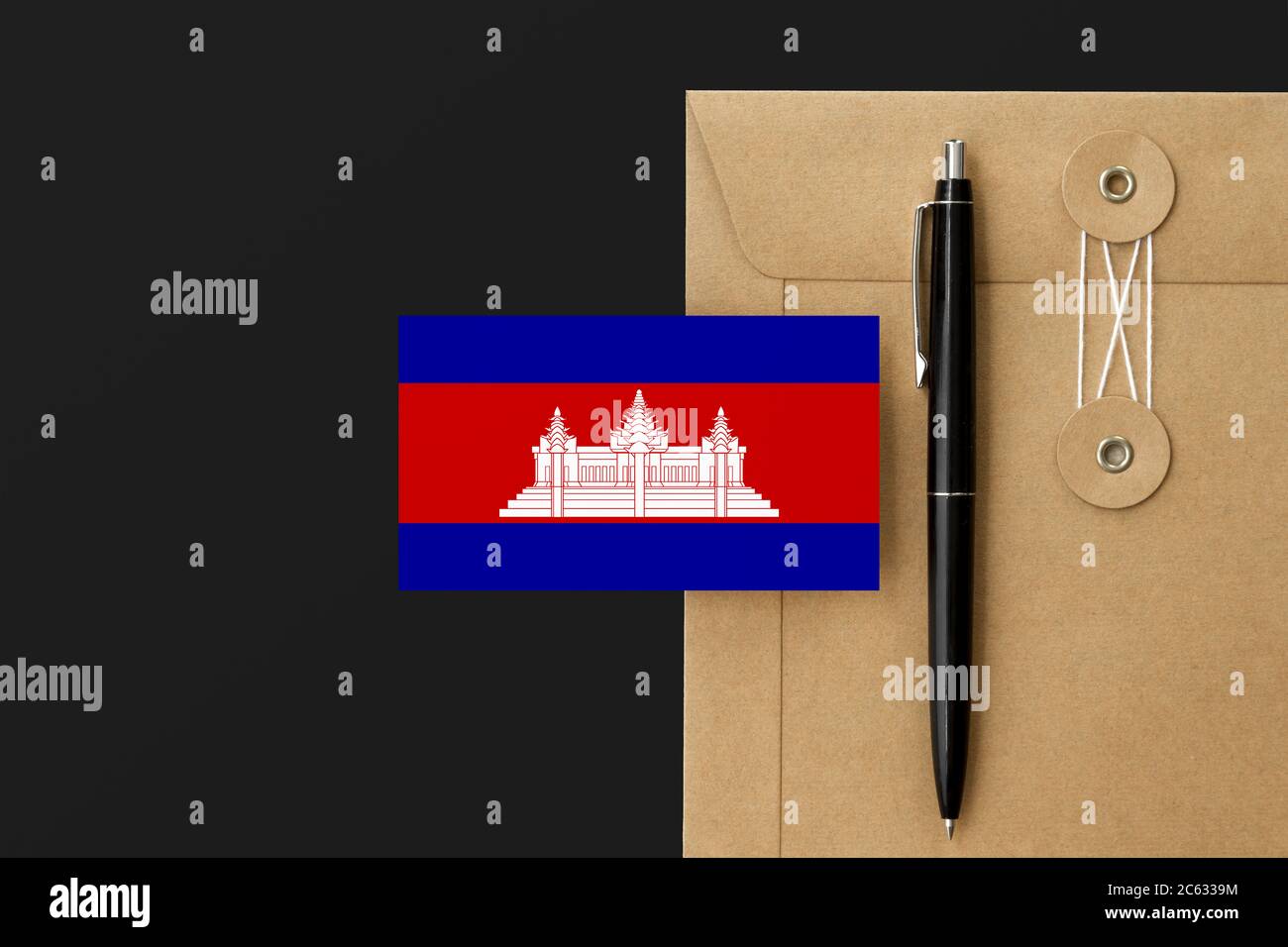 Cambodia flag on craft envelope letter and black pen background. National invitation concept. Invitation for education theme. Stock Photo