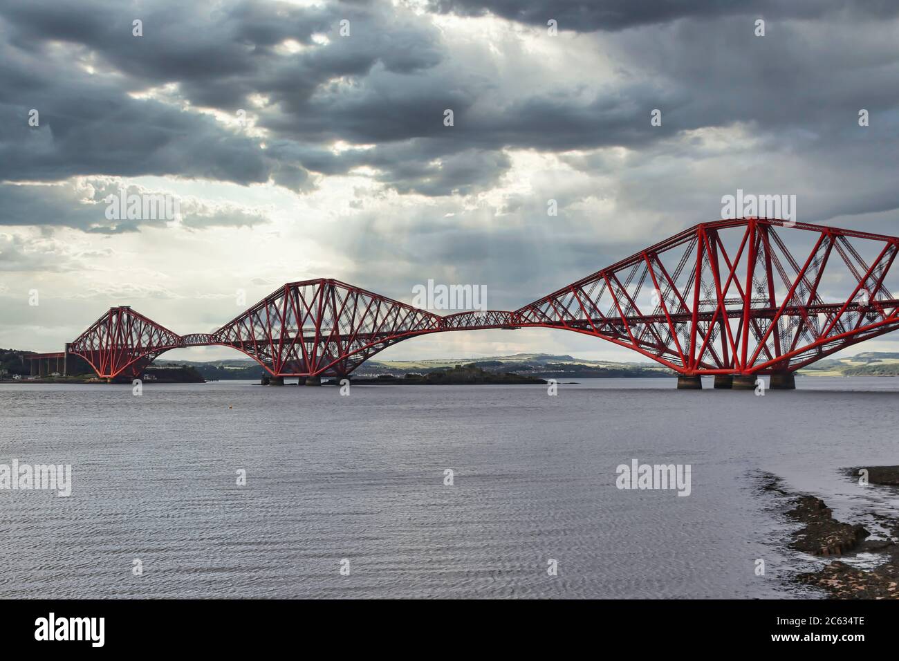 Forth Bridge from South Queensferry, Scotland, UK with dramatic cloudy sky Stock Photo