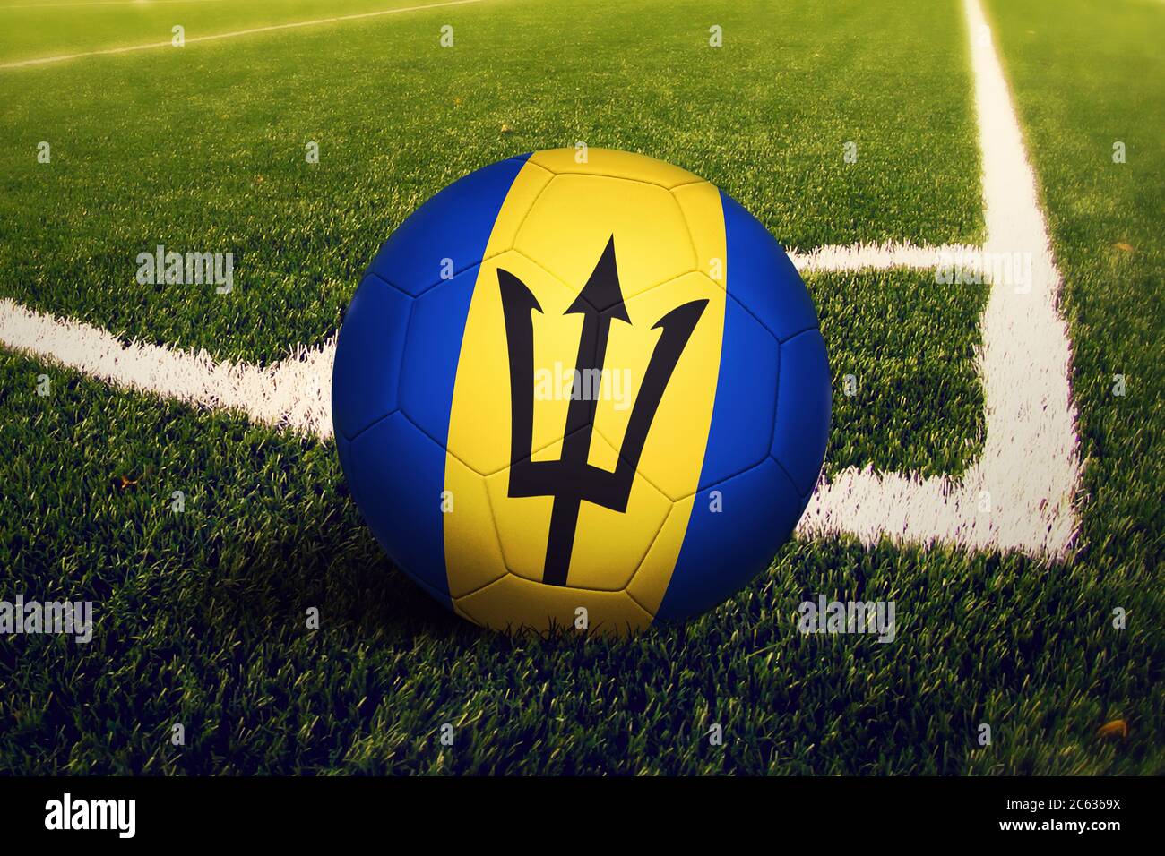 Barbados flag on ball at corner kick position, soccer field background