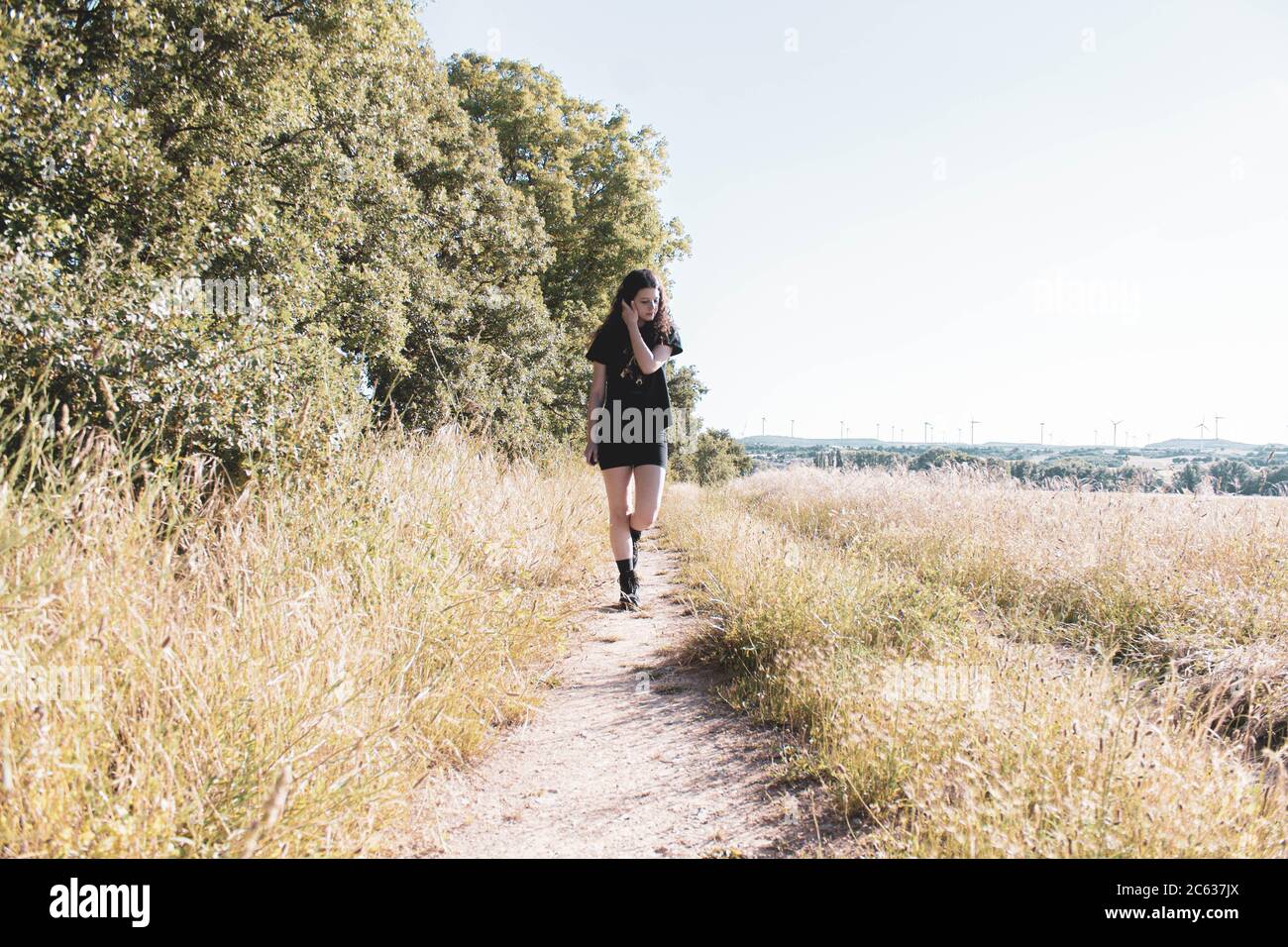 young woman hiking on a path in the middle of the forest Stock Photo ...