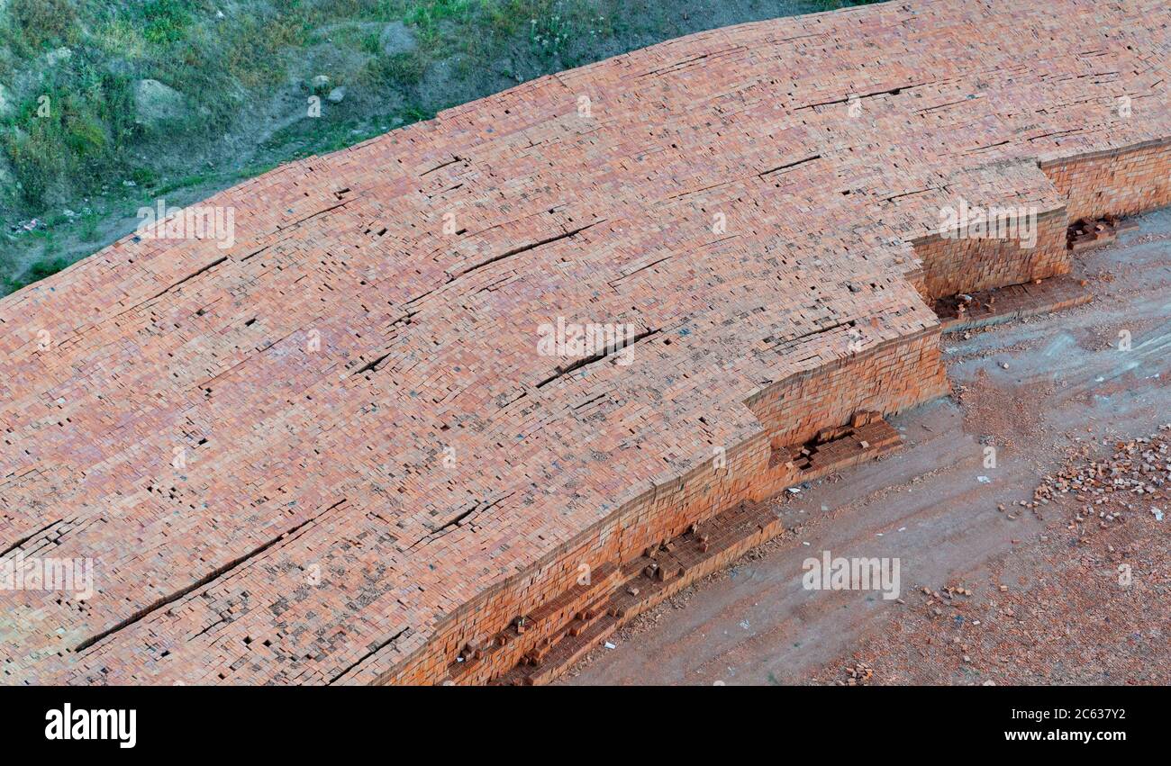 Top view of pile of red bricks lined up in row in a brick plant Stock Photo