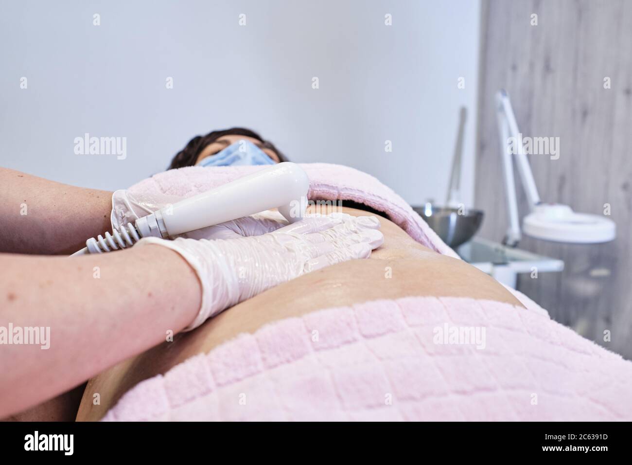 treatment in aesthetics center of diathermy for middle-aged women Stock Photo