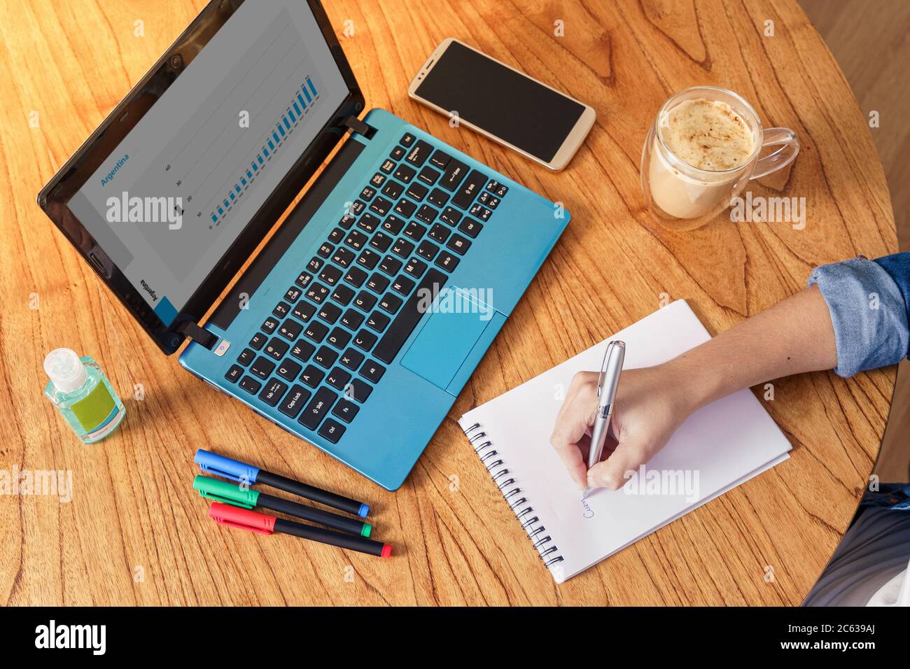 Coronavirus. Person making notes while working at home during quarantine..Top View Stock Photo