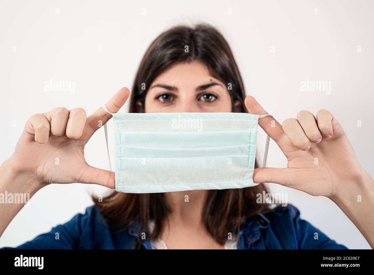 Portrait of a young woman wearing medical protective mask against covid ...