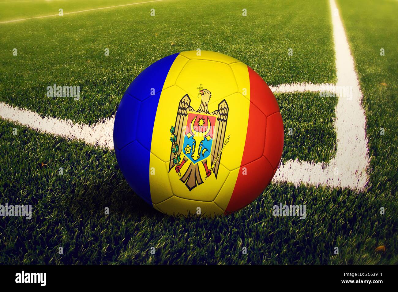 Moldova flag on ball at corner kick position, soccer field background