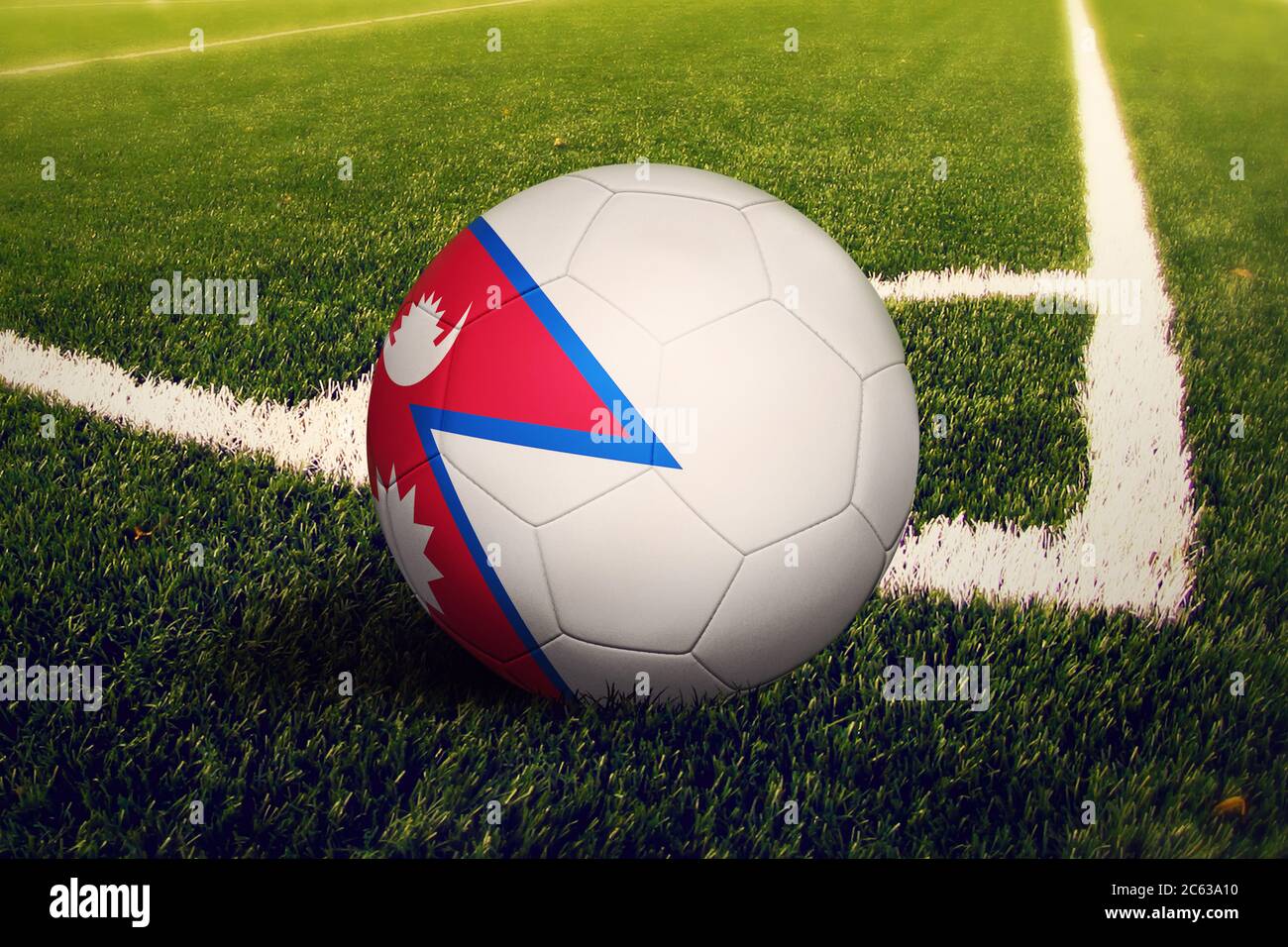 Nepal flag on ball at corner kick position, soccer field background. National football theme on