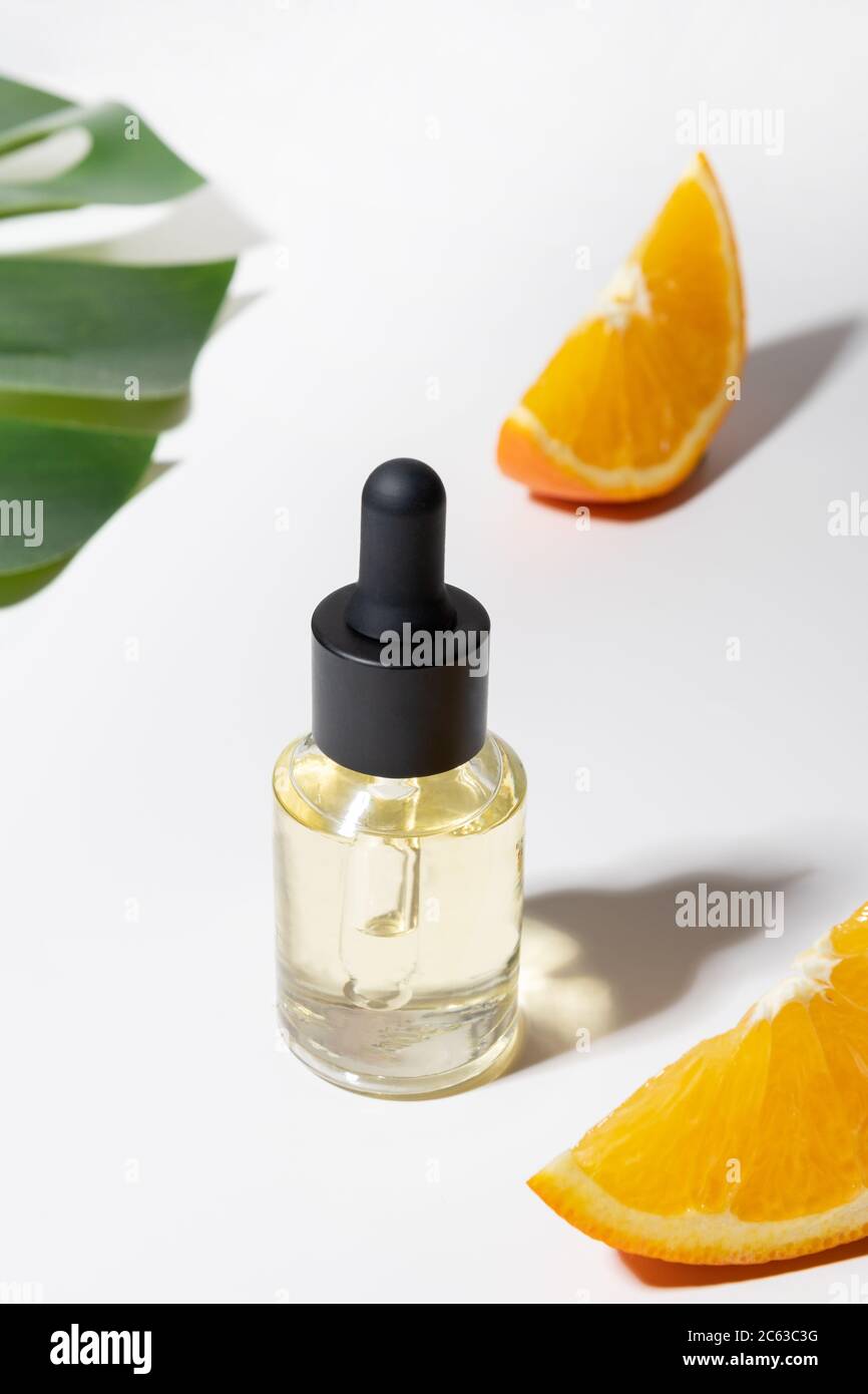 Cosmetic hyaluronic acid and orange on white. Close up. Anti-cellulite care. Stock Photo