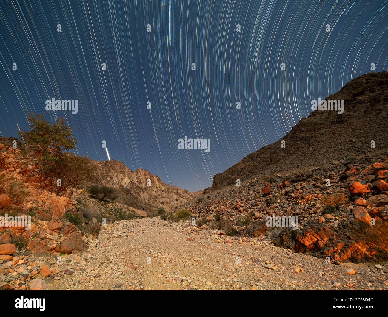 Star trails at night in Wadi Al Arbeen, Sultanate of Oman. Stock Photo