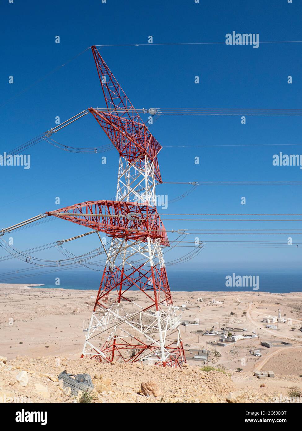 High tension power lines overlooking Wadi Fins, Sultanate of Oman. Stock Photo