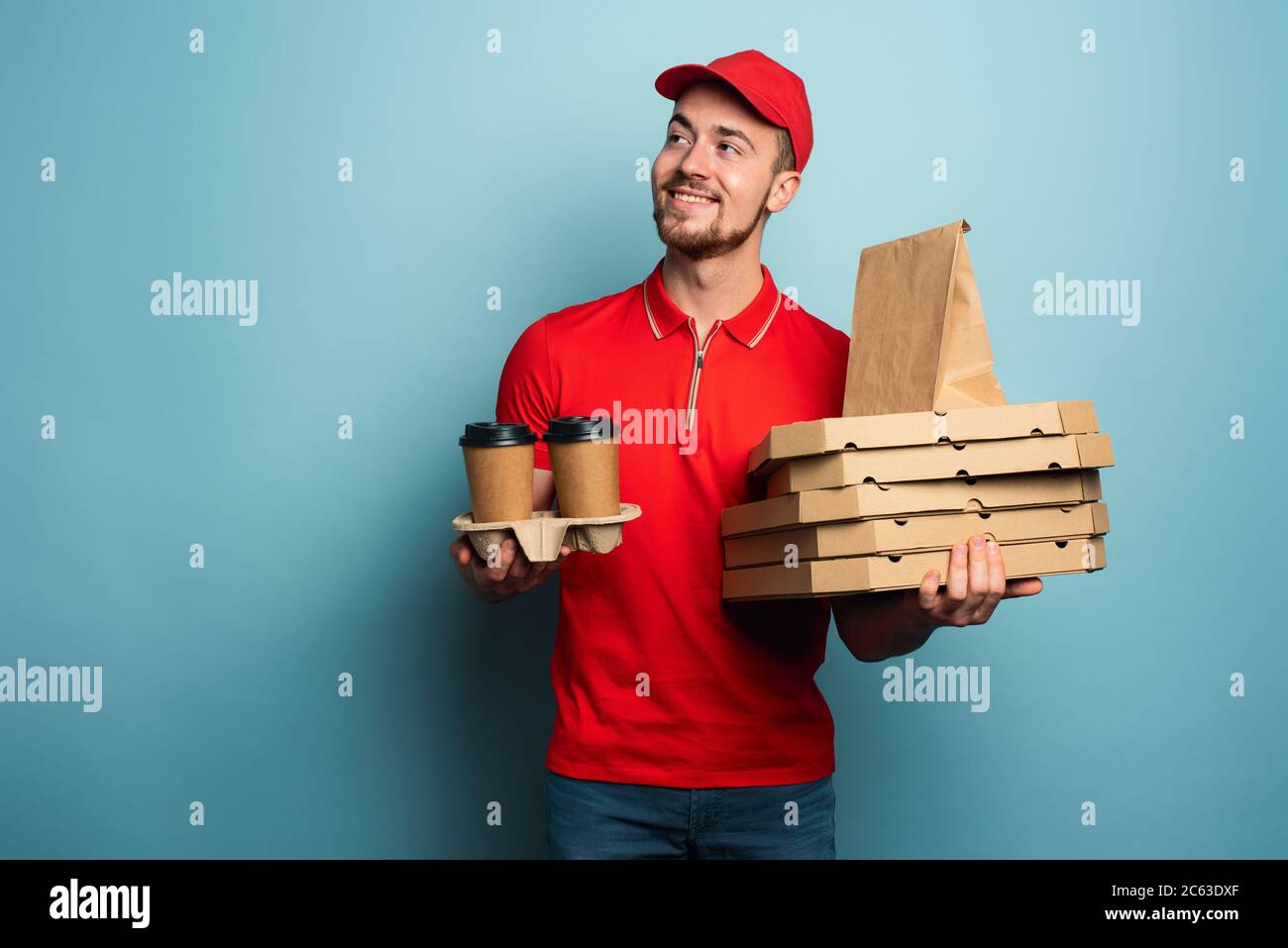 Courier is happy to deliver hot coffee,pizza and food. Cyan background Stock Photo