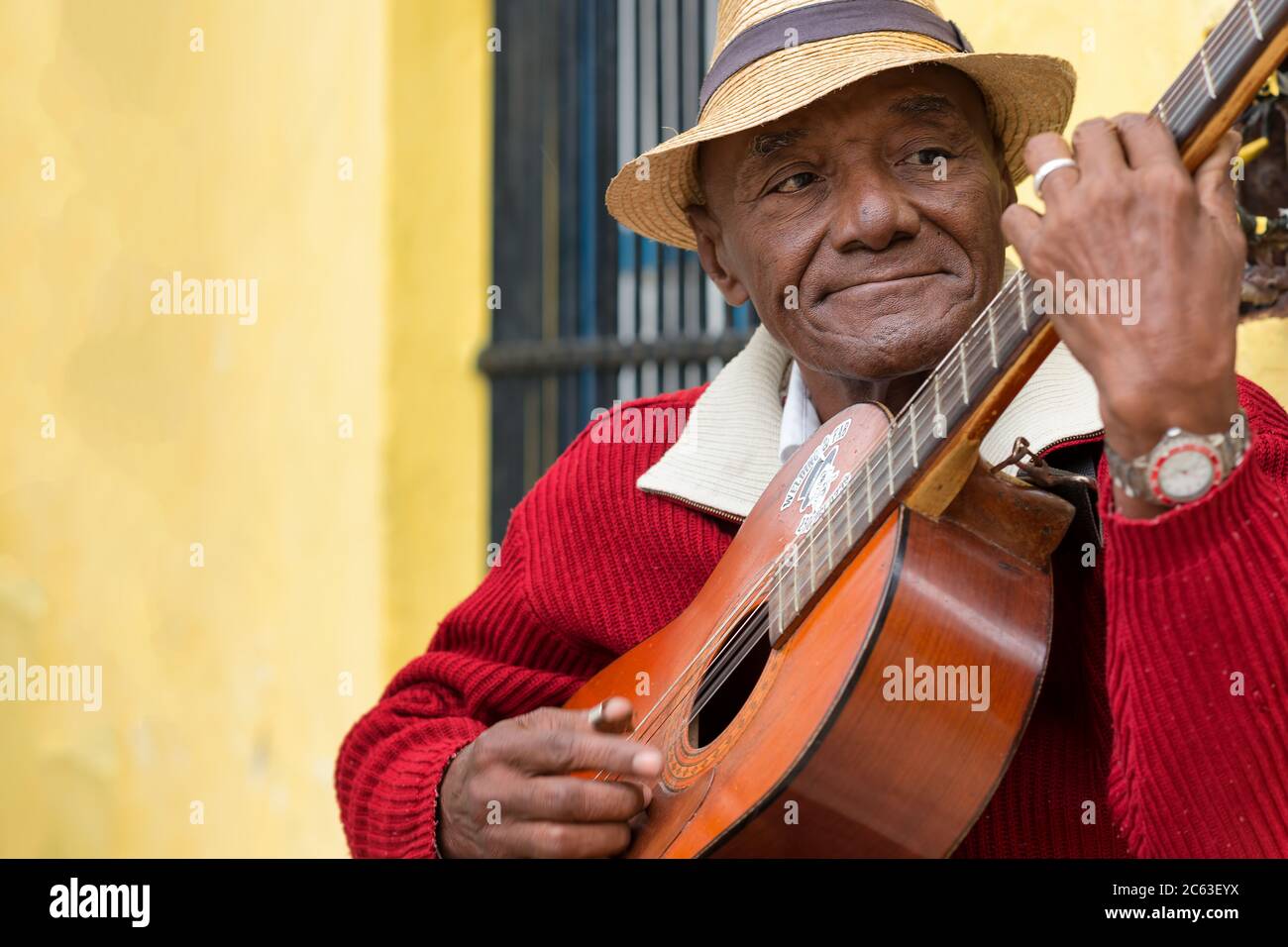 Old cuban man  playing traditional music on a guitar in Old Havana Stock Photo