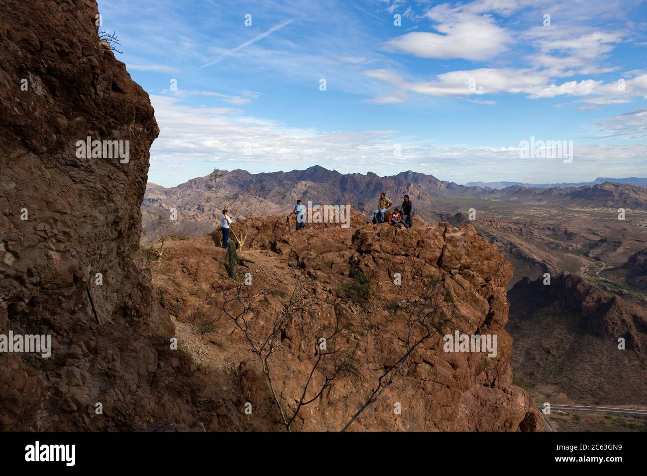 Two men and three boys hike Tetakawi Mountain in San Carlos, Sonora, Mexico. Stock Photo