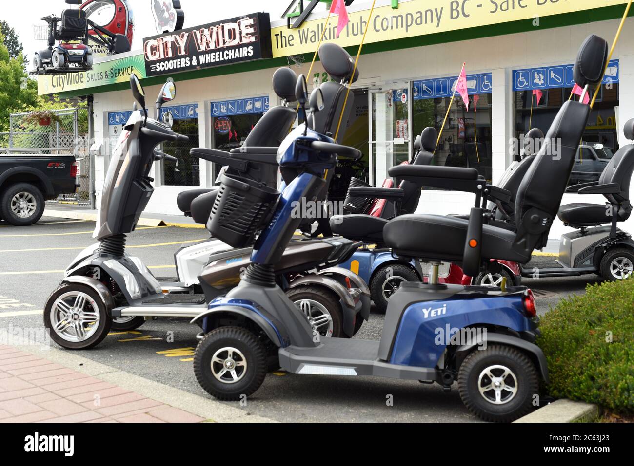 Personal mobility scooters sit outside the City Wide Scooters & Wheelchair store in Langford, British Columbia, Canada. Stock Photo