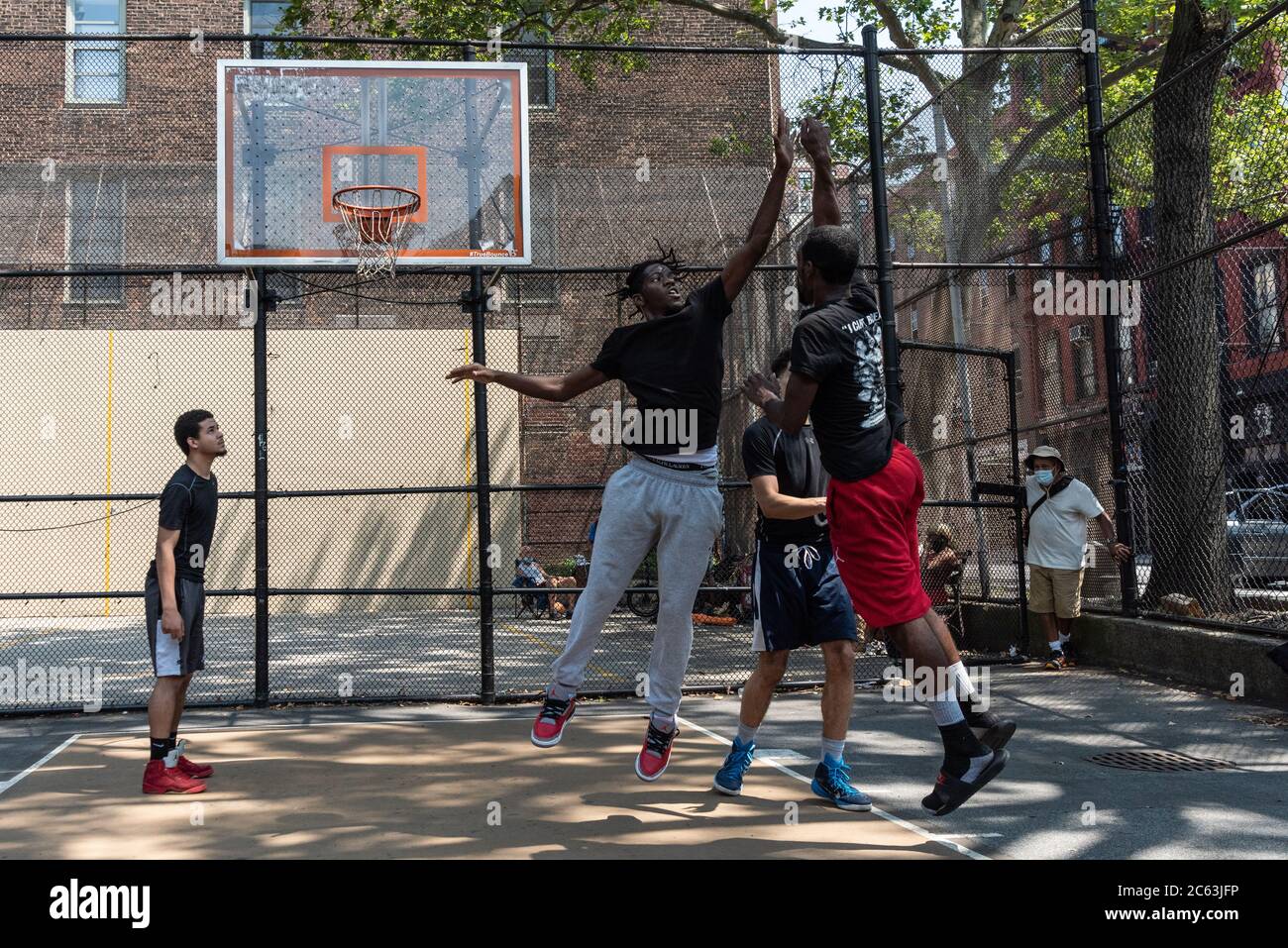 Players engage in a competitive game of basketball at the iconic West 4th  Street Courts or "The Cage" as New York City enters Phase 3 of the  Coronavirus opening on July 6,