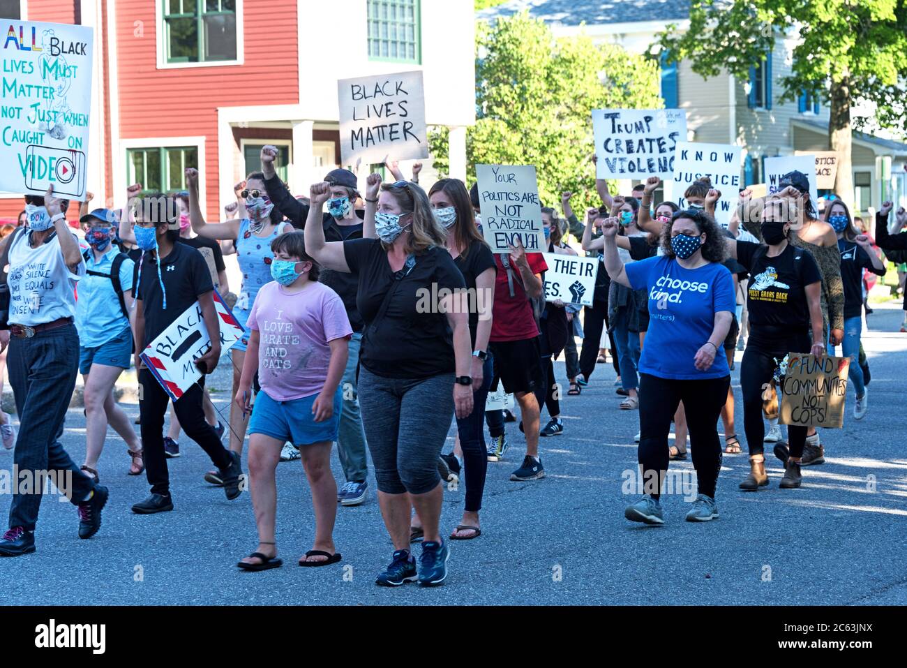 Bar Harbor, Maine, USA. 06 July, 2020. Marchers in a protest led by the Mount Desert Island Racial Justice Collective walk silently down Ledgelawn Avenue with a fist raised in support of Black Lives Matter. ©Jennifer Booher/Alamy Live News Stock Photo