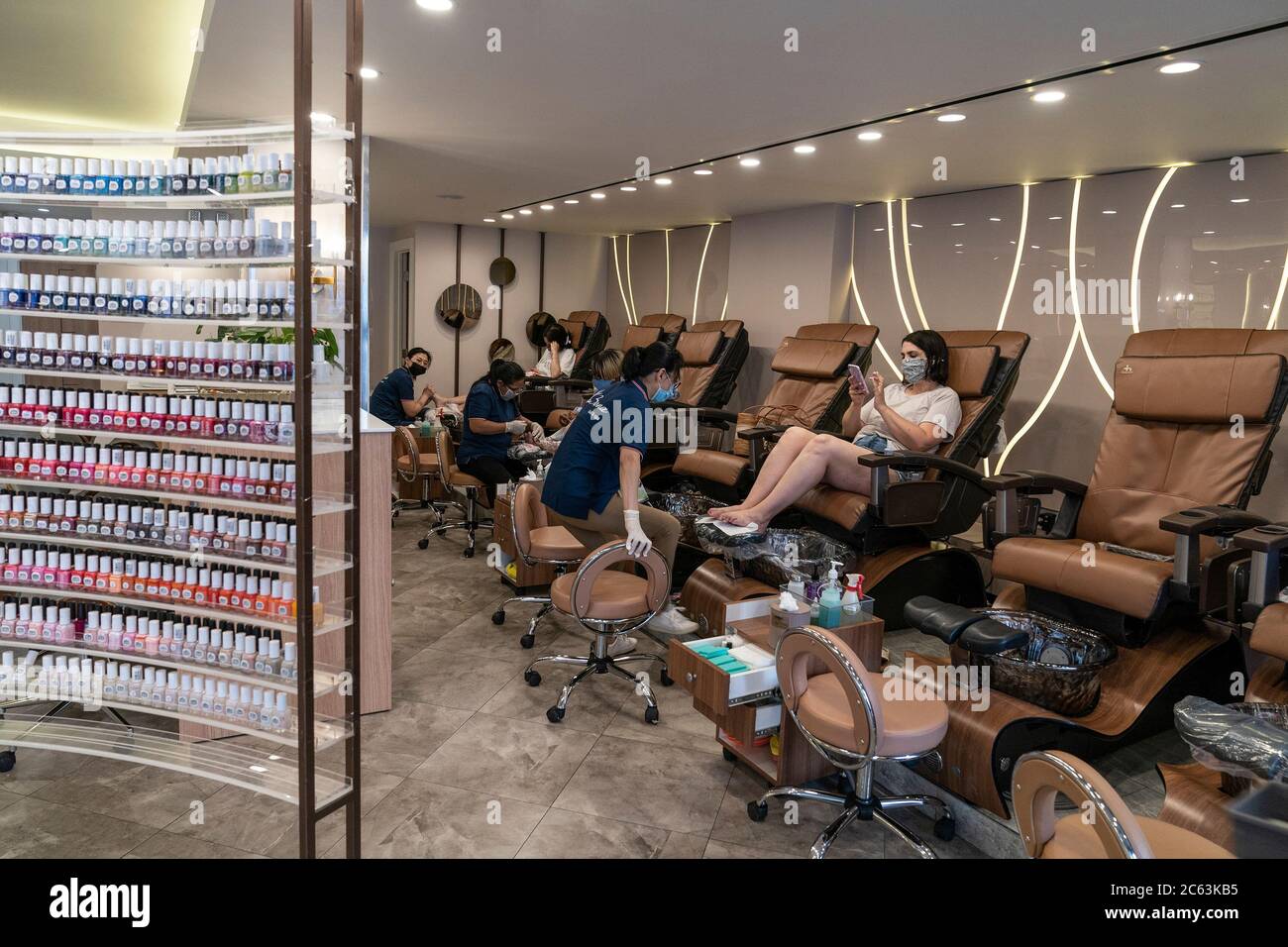 nail salons are opened for business as part of phase three of reopening amid covid 19 pandemic in new york on july 6 2020 view of bona nail salon with customers and employees wearing faca masks and gloves and keeping social distance salons are required to serve up to 50 capacity photo by lev radinsipa usa 2C63KB5