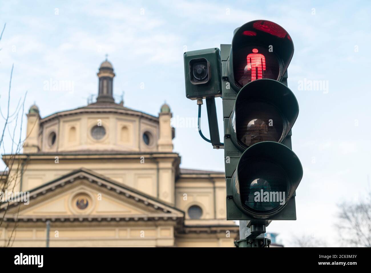 Traffic light in Milan Garibaldi infront of a church Stock Photo