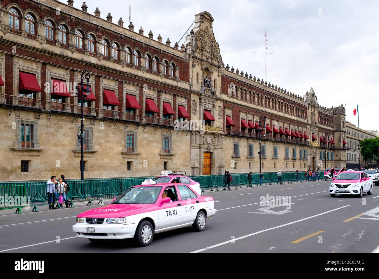 Typical pink taxis next to the National Palace in the historical center ...