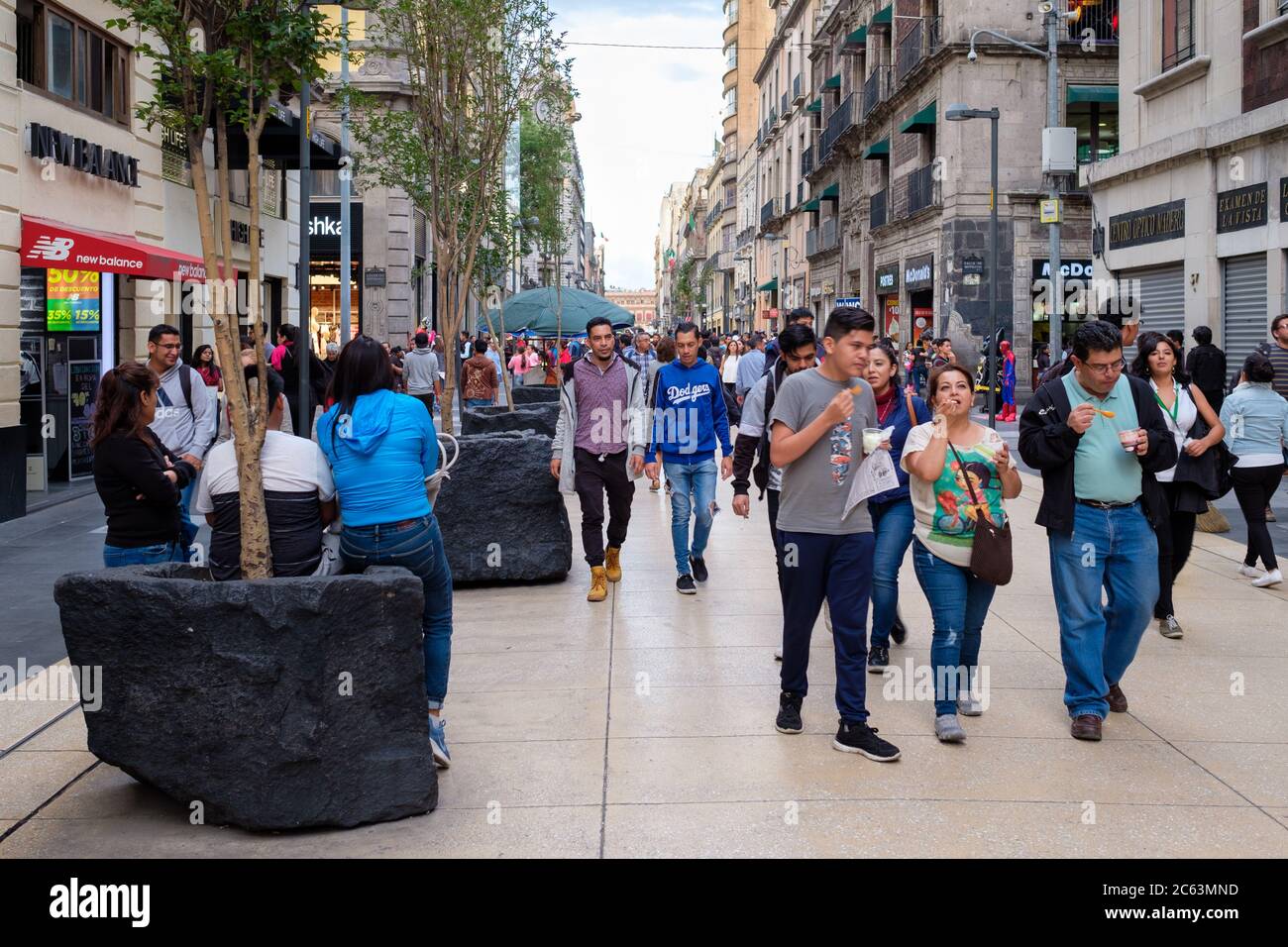 People, shops and restaurants at the always busy Madero boulevard in  downtown Mexico City Stock Photo - Alamy