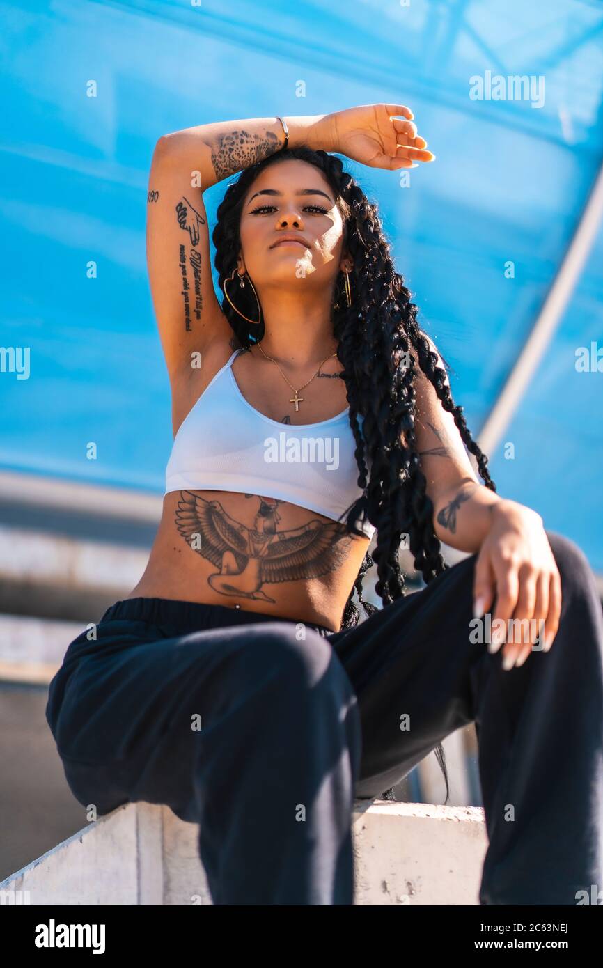 Young black girl with tattoos, trap dancer with arm up Stock Photo - Alamy