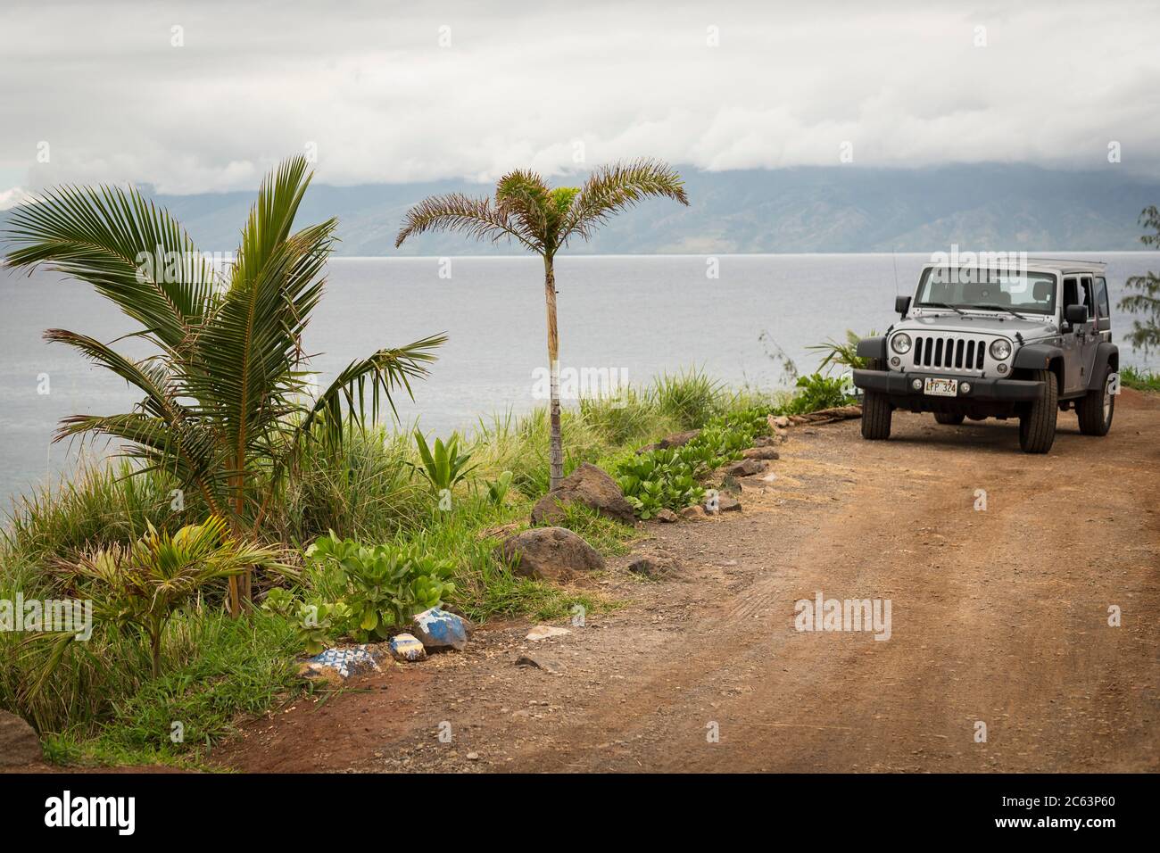 A Jeep Wrangler parked in Honolua Bay placed at the north of Maui Stock Photo