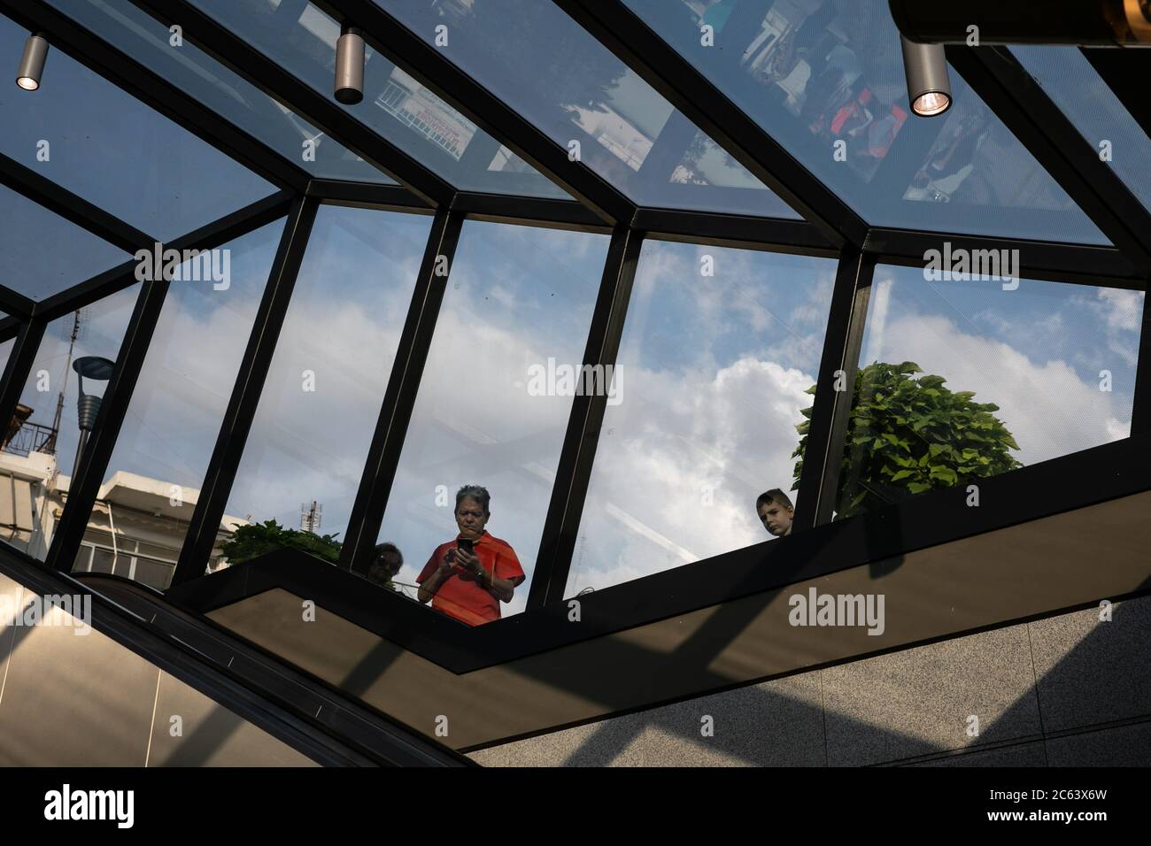 Athens, Greece. 6th July, 2020. People are seen through the glass ceiling  of Nikea metro station in Athens, Greece, July 6, 2020. Greek Prime  Minister Kyriakos Mitsotakis inaugurated on Monday three new