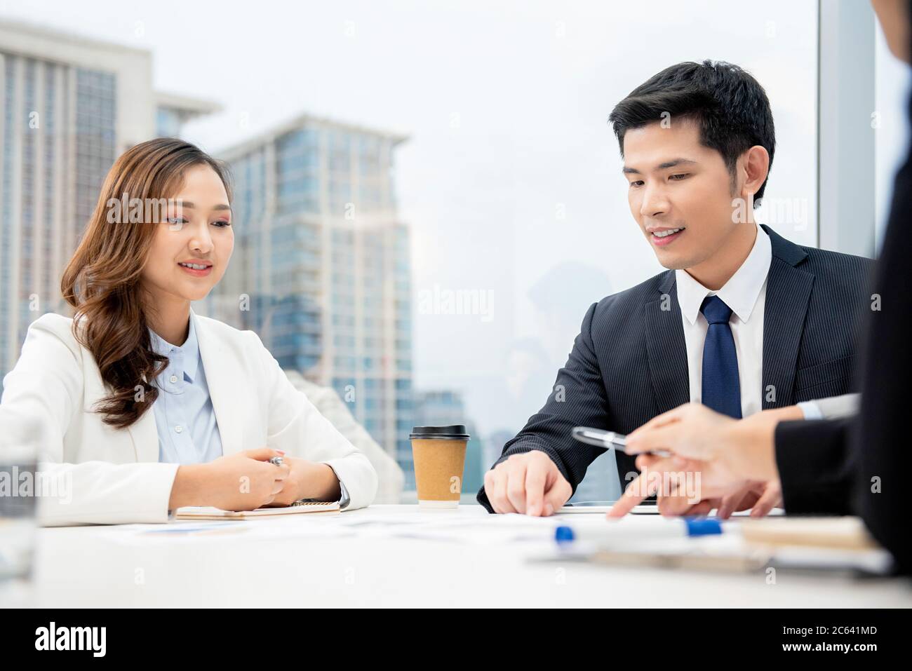 Young Asian businesspeople at the meeting in city office Stock Photo
