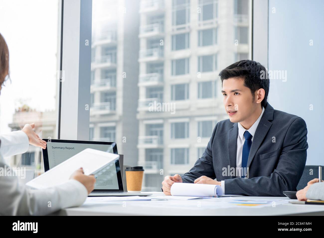 Handsome Asian businessman listening to presentation at the meeting city office Stock Photo