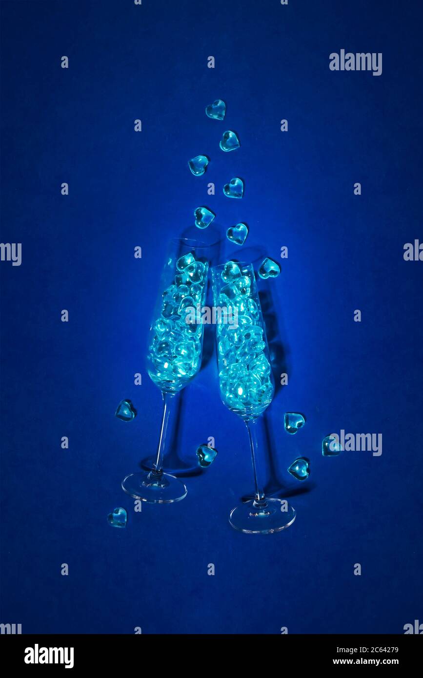 Champagne glasses filled with blue hearts. gay party concept Stock Photo
