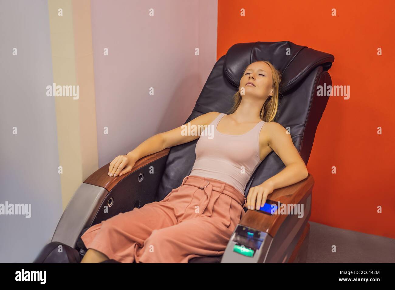 Beautiful young woman relaxing on the massage chair in airport or in the  mall Stock Photo - Alamy
