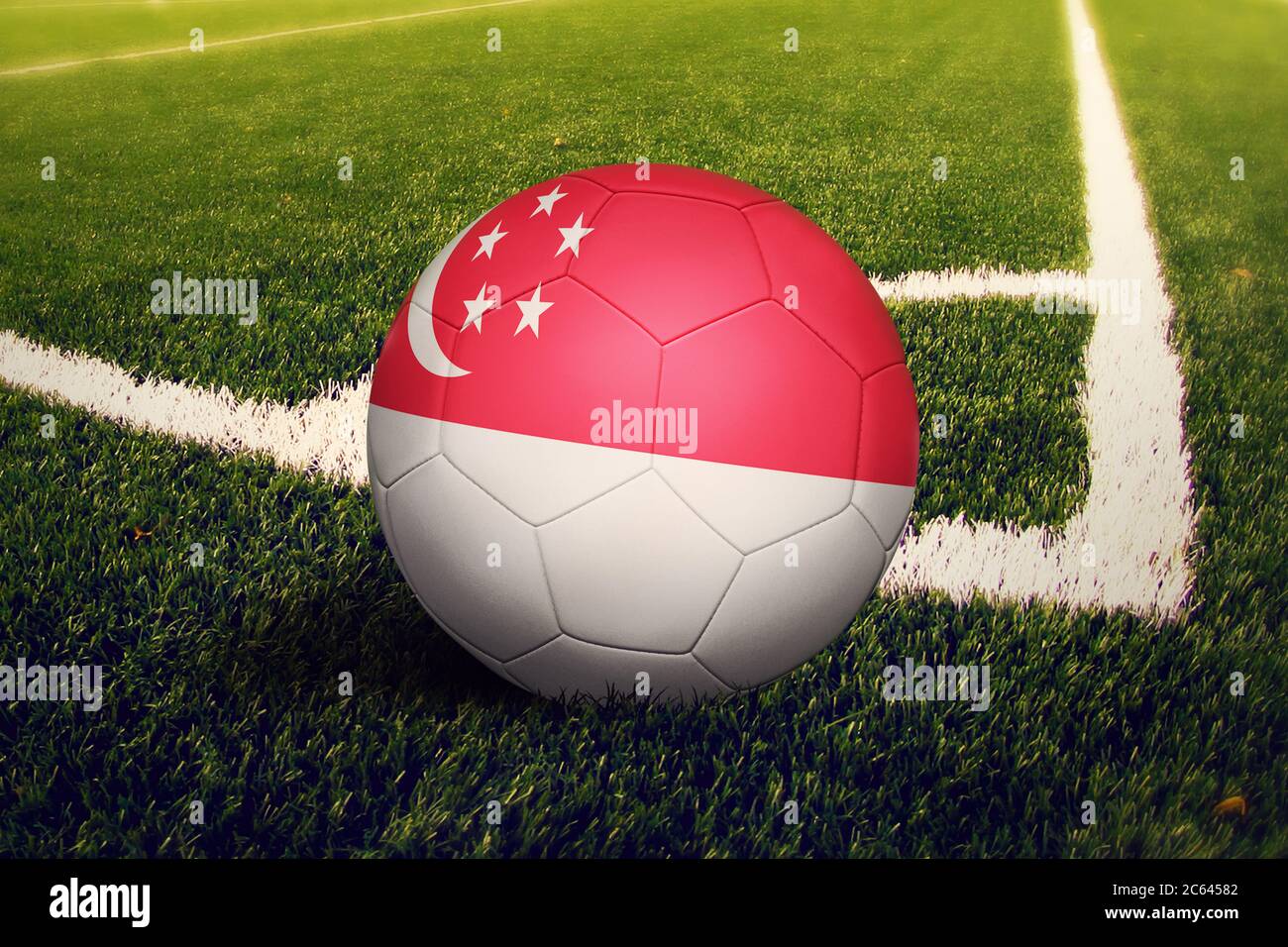 Singapore flag on ball at corner kick position, soccer field background