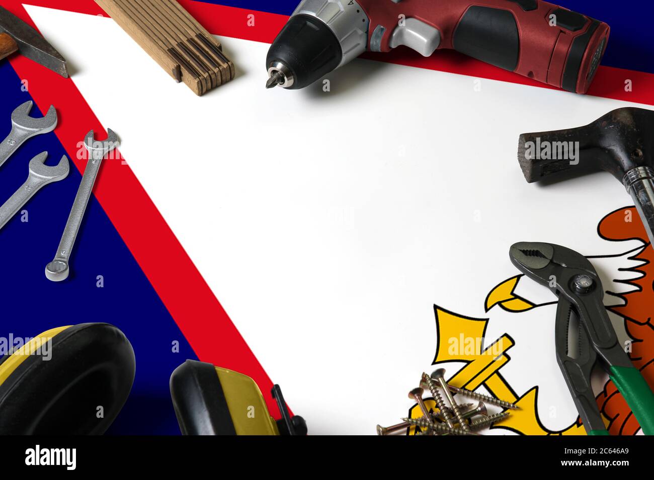 American Samoa flag on repair tool concept wooden table background. Mechanical service theme with national objects. Stock Photo