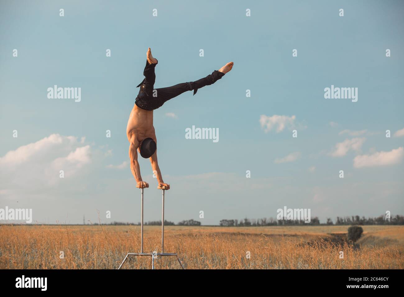 performance of an aerialist outdoors during sunset Stock Photo