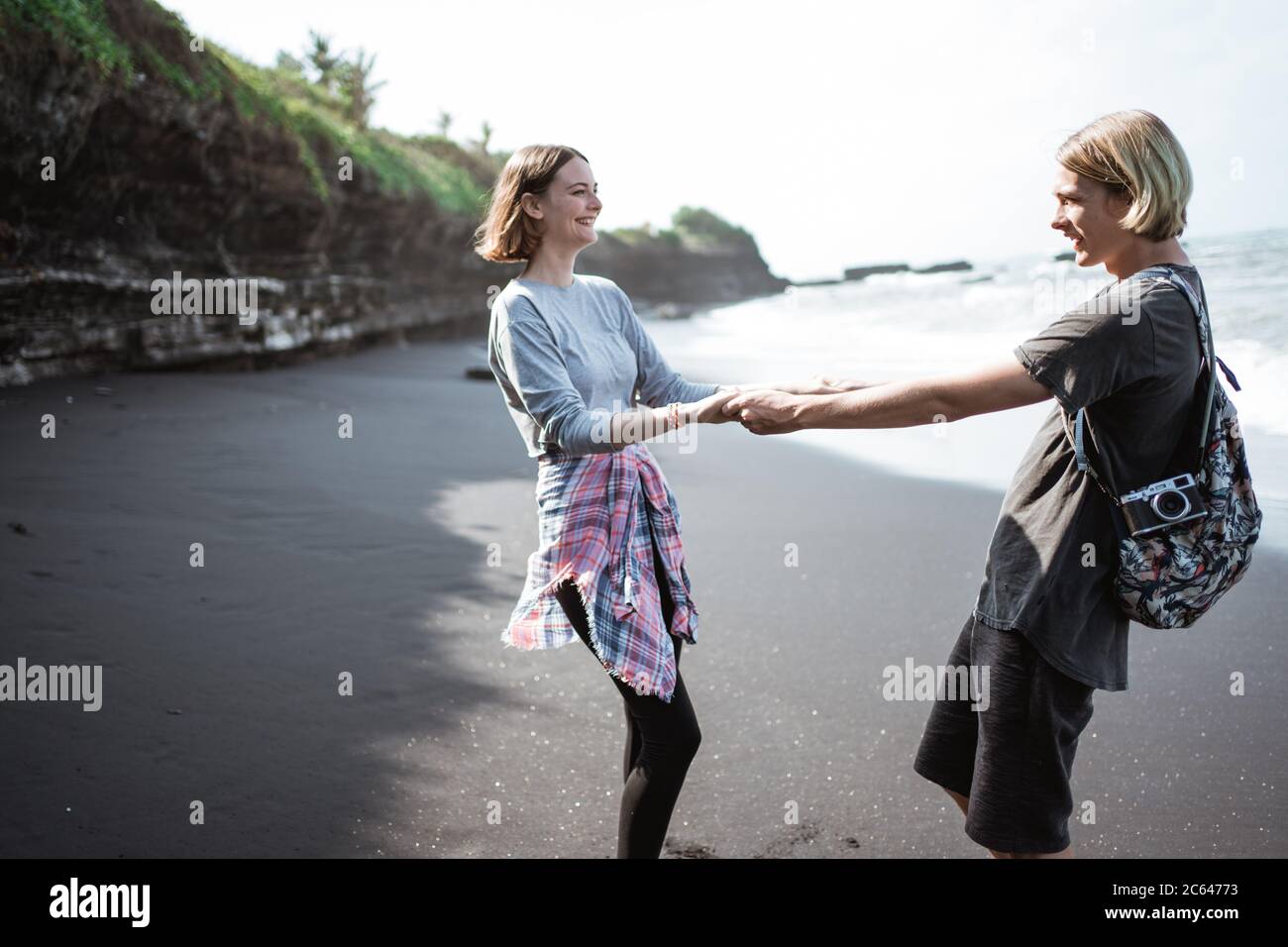 Young couple enjoy a trip together on the beach in the bright sunny day Stock Photo
