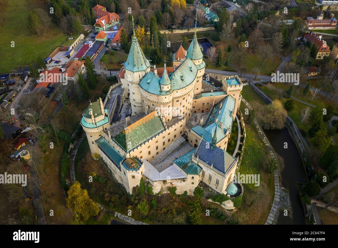 Bojnice castle from bird's eye view encircled by moat, greenery and buildings. Stock Photo
