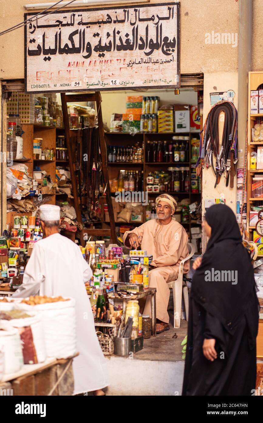 Nizwa / Oman - February 15, 2020: Portrait of adult Muslim Omani man shop  seller wearing traditional clothing in Nizwa covered souq in front of shop  Stock Photo - Alamy