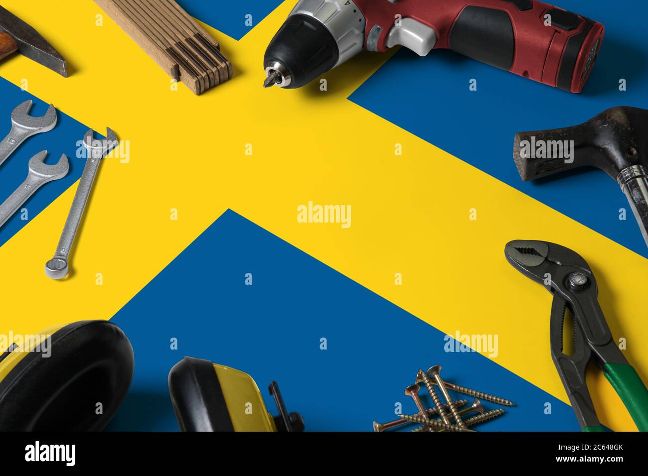 Sweden flag on repair tool concept wooden table background. Mechanical service theme with national objects. Stock Photo