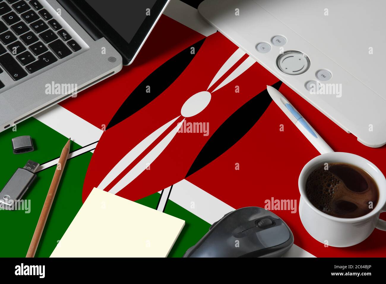 Kenya national flag on top view work space of creative designer with