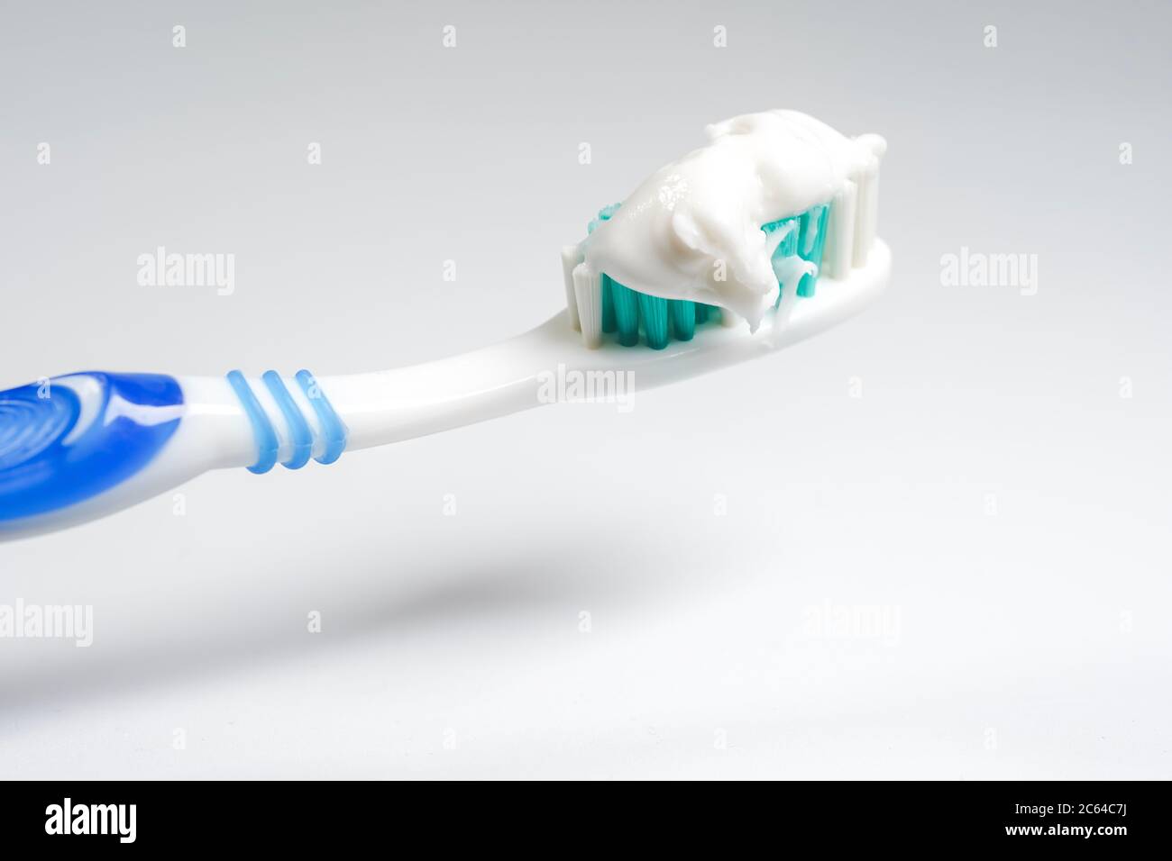 Toothbrush with toothpaste isolated on white background Stock Photo - Alamy
