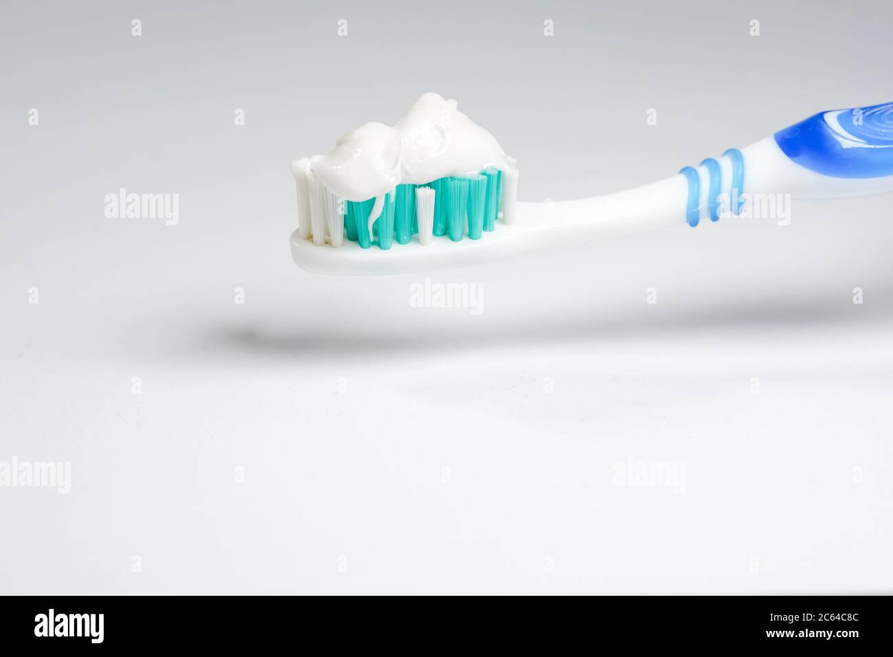 Toothbrush with toothpaste isolated on white background Stock Photo