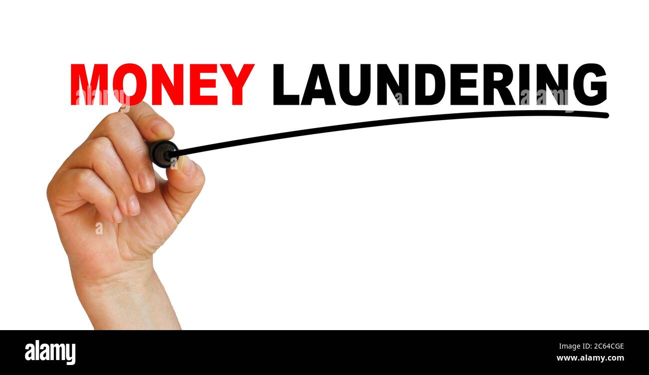 Hand underlining money laundering with red marker Stock Photo