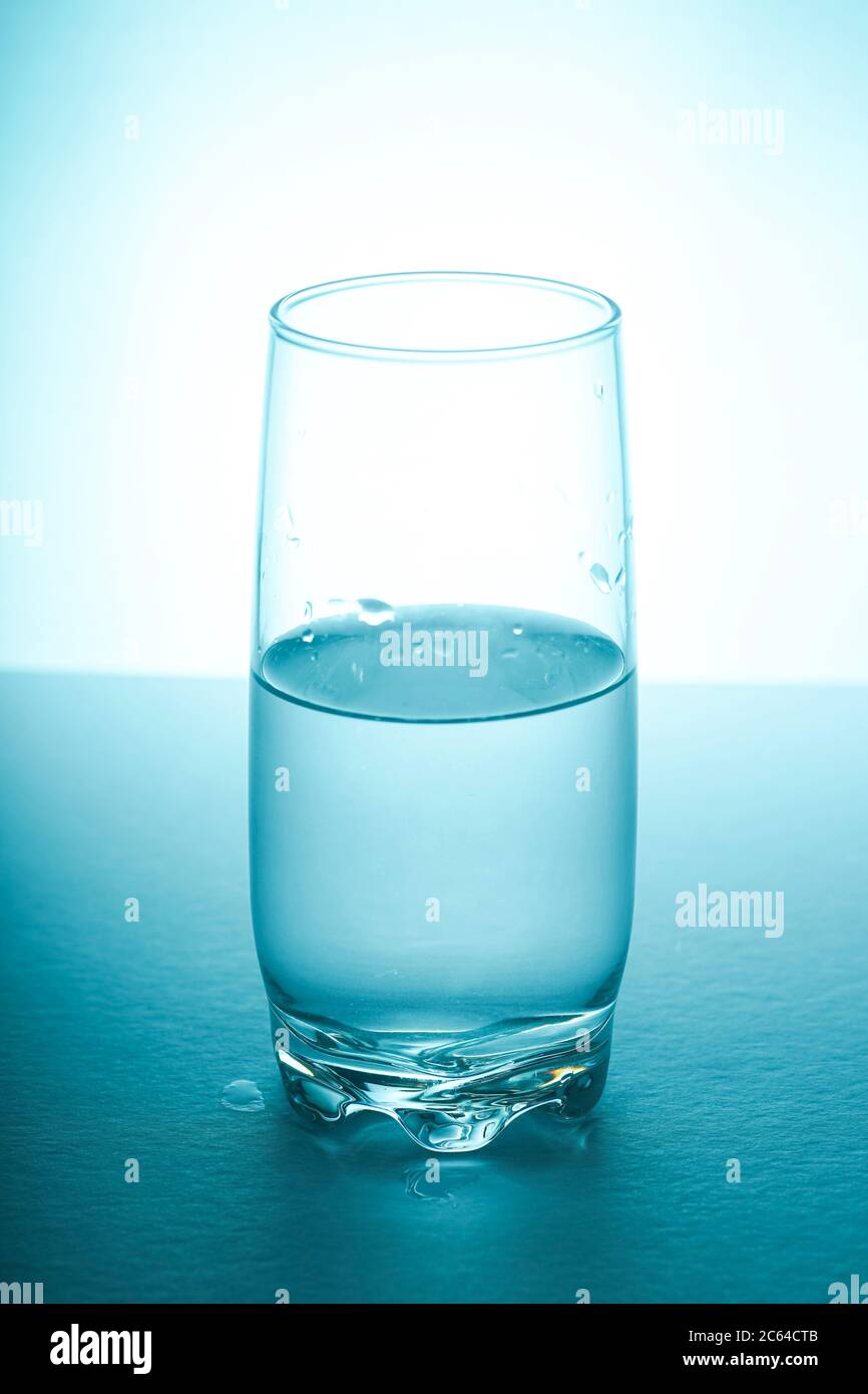 Glass half empty or glass half full. Psychology or motivational concept Stock Photo Alamy