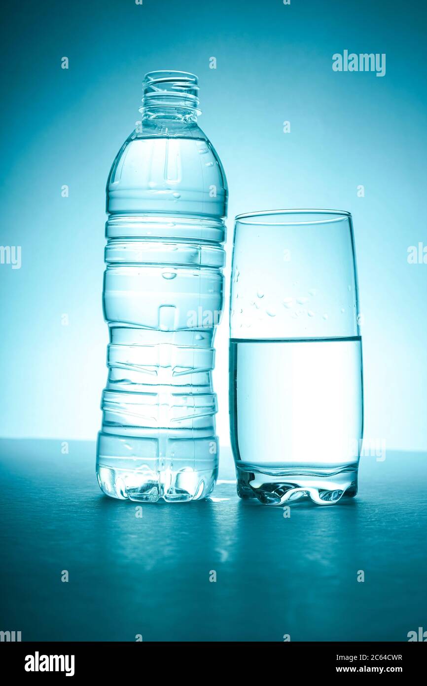 Bottle fills with water, isolated Stock Photo - Alamy