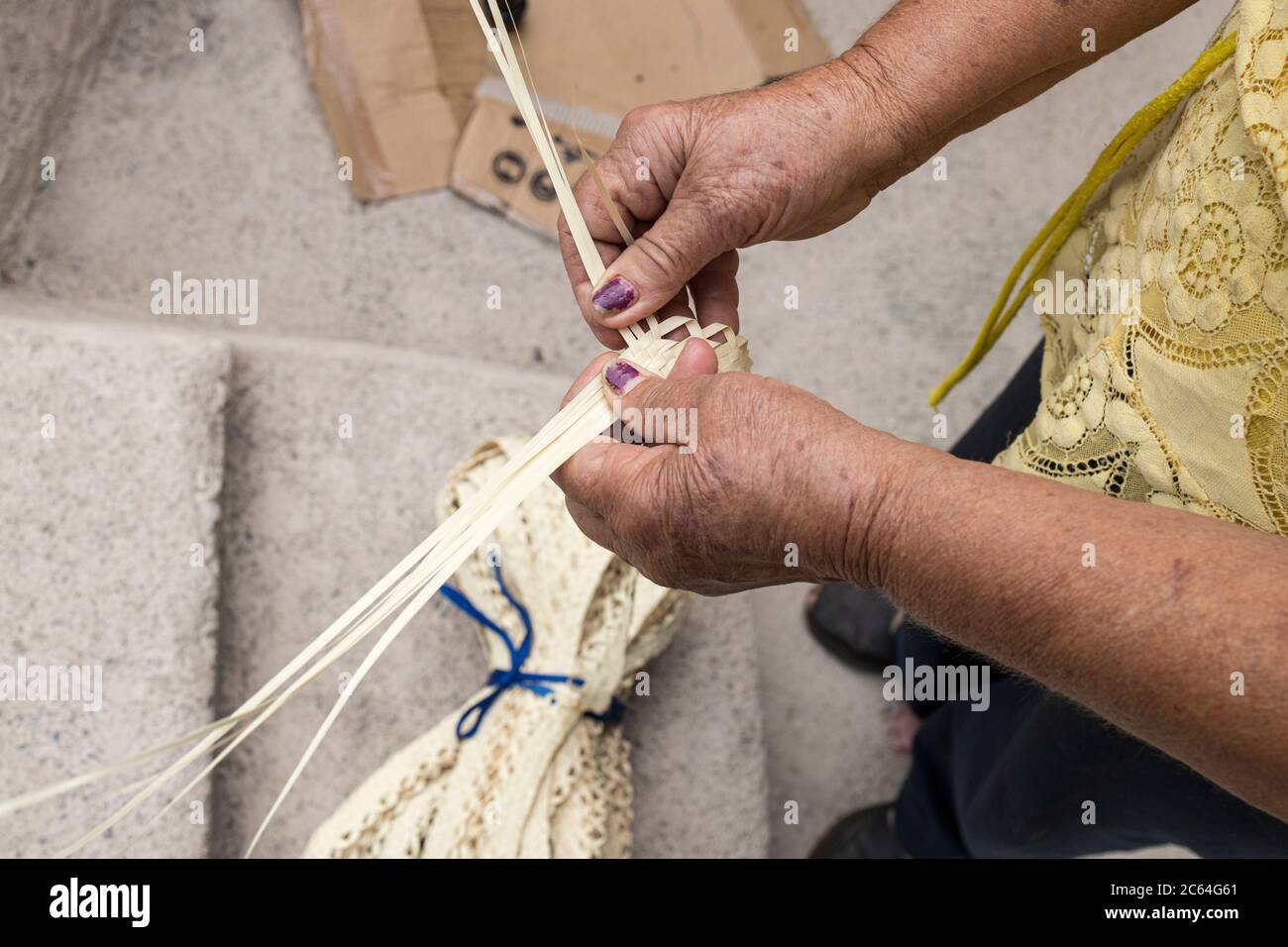 Algeria demonstrates how she weaves palm fronds together to make traditional hats, Masca, Tenerife, Canary Islands, Spain Stock Photo