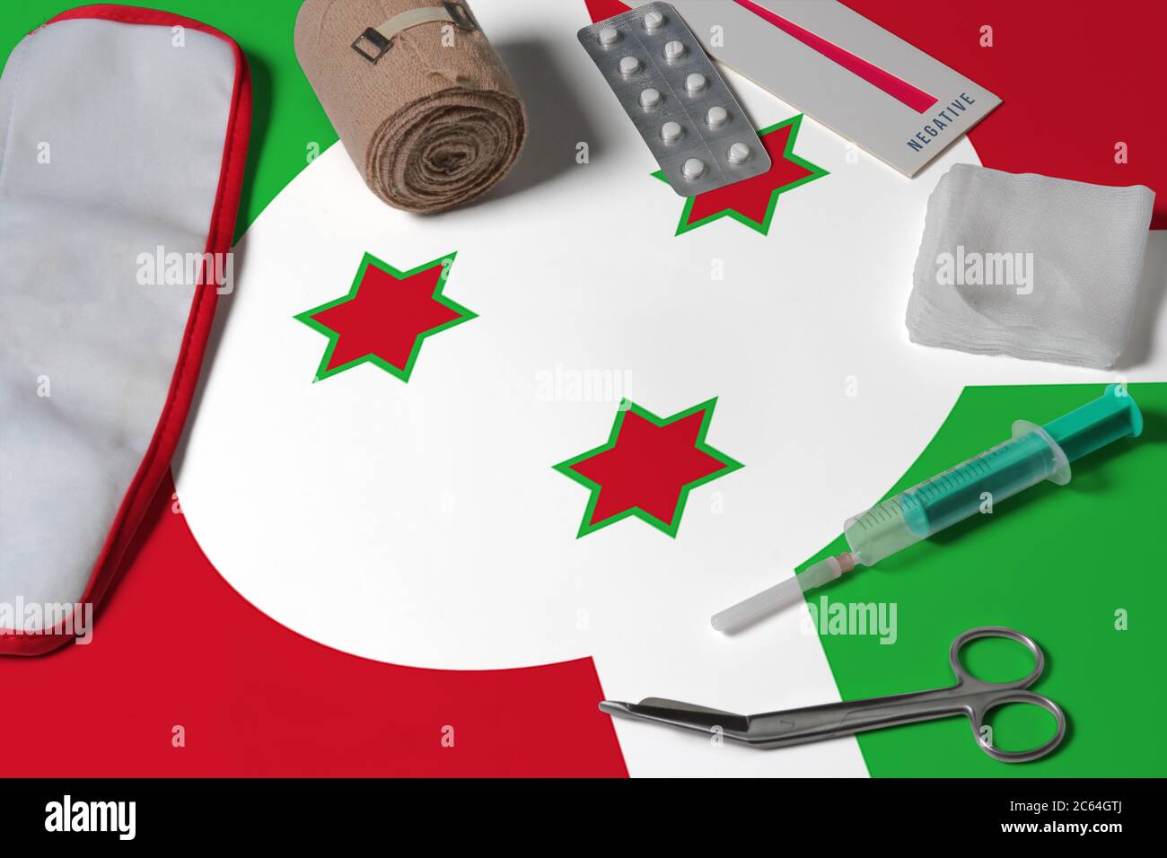 Burundi flag with first aid medical kit on wooden table background