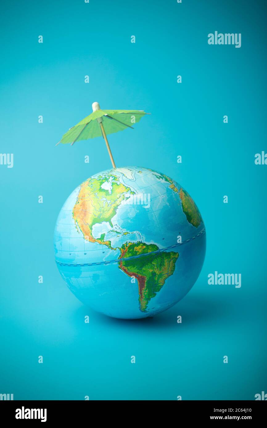 Global warming and climate change on earth concept. Earth globe on a blue  background with an umbrella. Protecting the atmosphere from ultraviolet  radi Stock Photo - Alamy