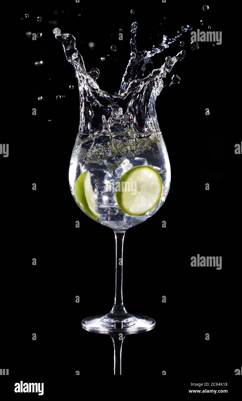 gin tonic cocktail splashing isolated on black background Stock Photo