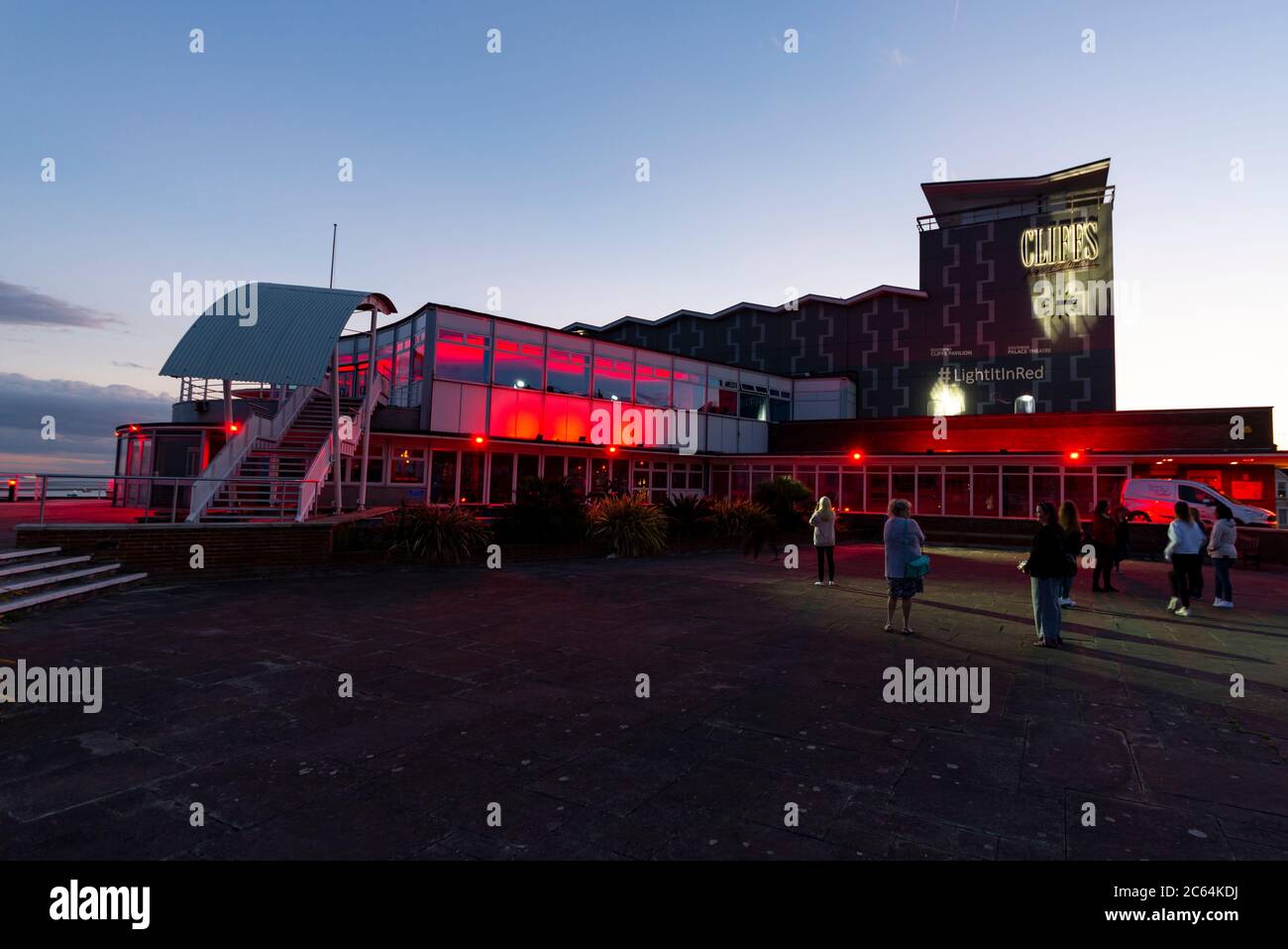 Cliffs Pavilion theatre illuminated red in support of entertainment and event industry during COVID-19 lockdown. Light it in red. Furloughed employees Stock Photo