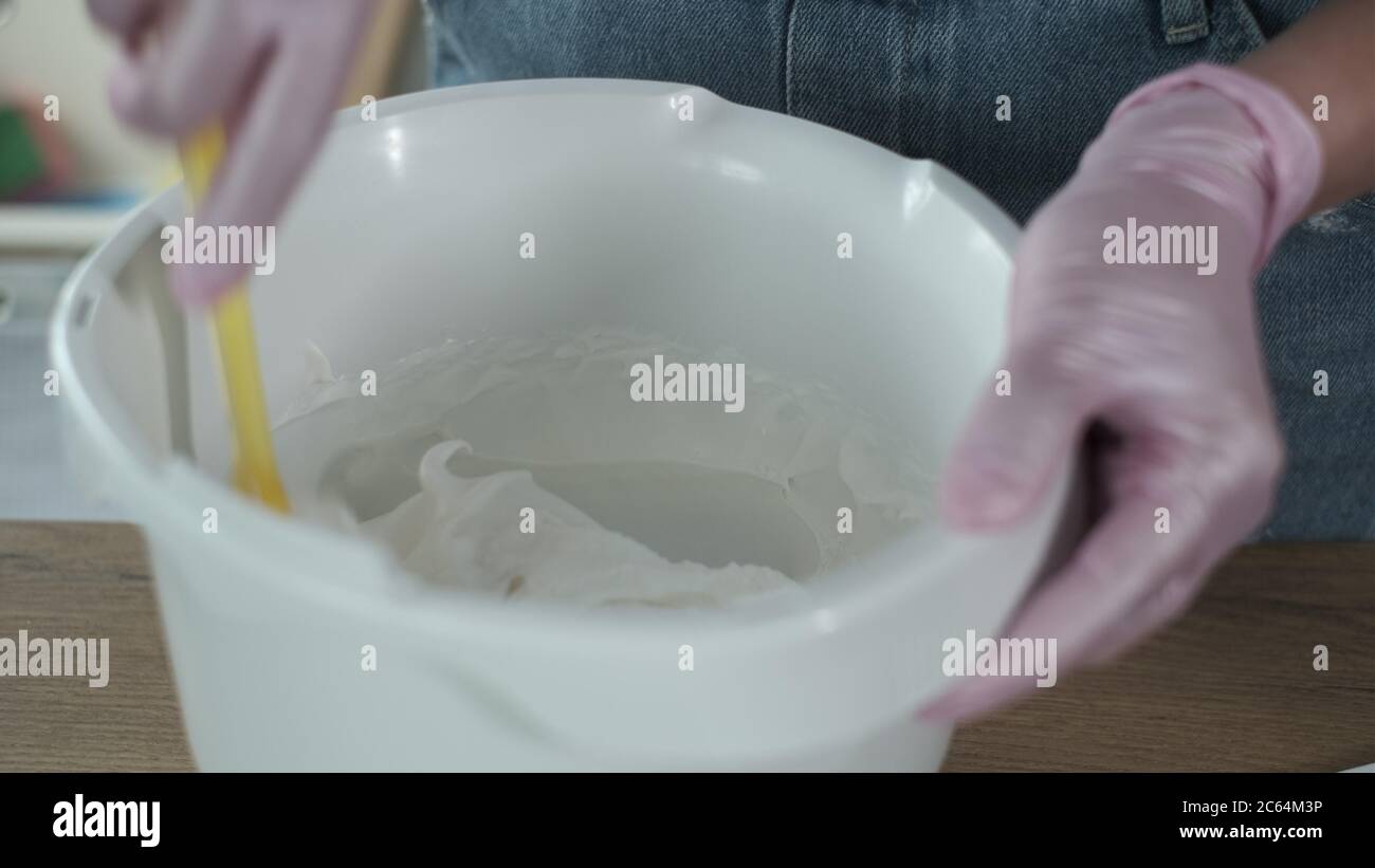 Crop woman adding sugar into bitten eggs Stock Photo